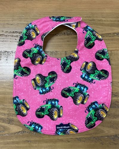 Bright pink tractor baby bib